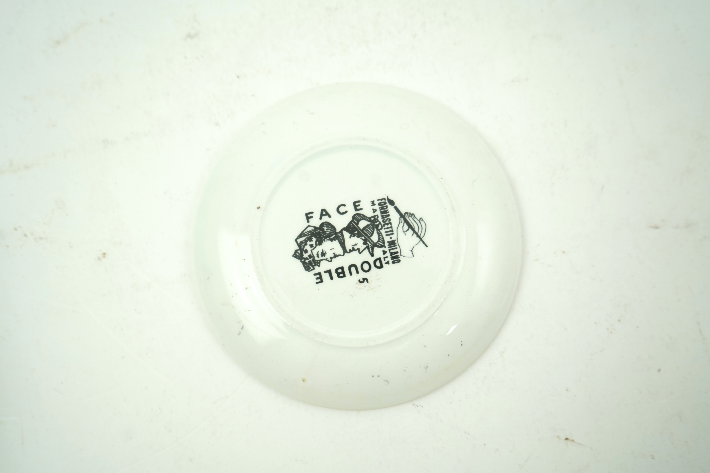 Piero Fornasetti (Italian, 1913-1988): A collection of Fornasetti desk items and dishes